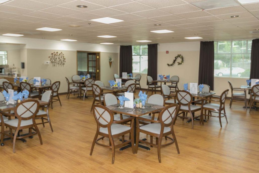 A neatly arranged dining area with several tables and chairs, featuring elegant decor.