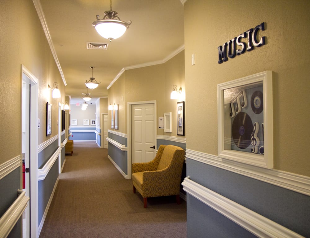 A well-lit hallway with music-themed artwork and comfortable seating.
