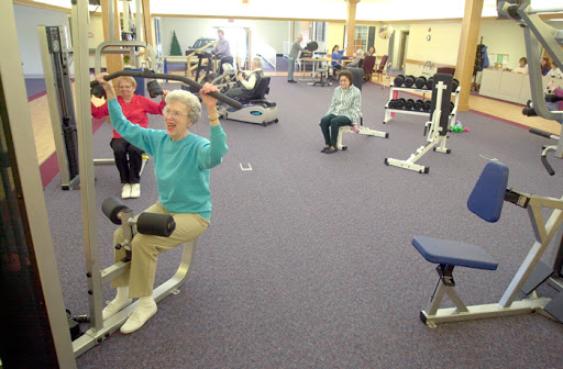 Seniors engaging in a group exercise session at a fitness center.