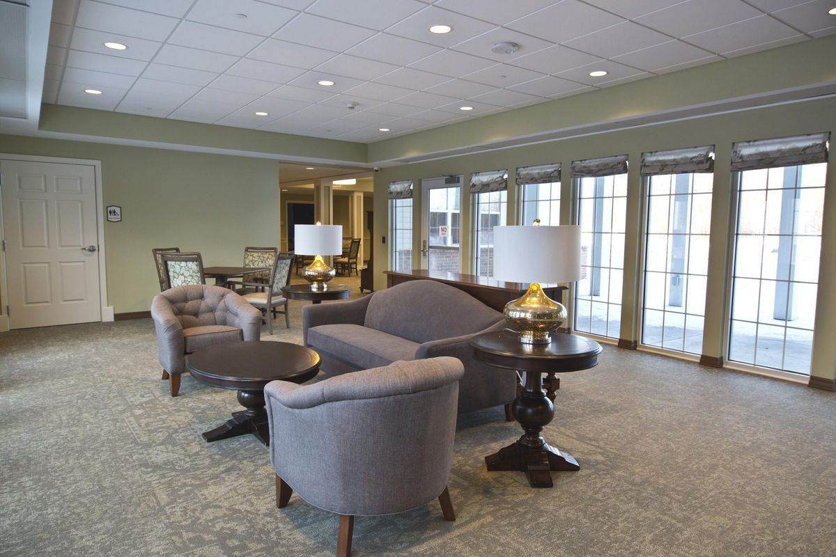 A modern living room with comfortable seating and large windows.