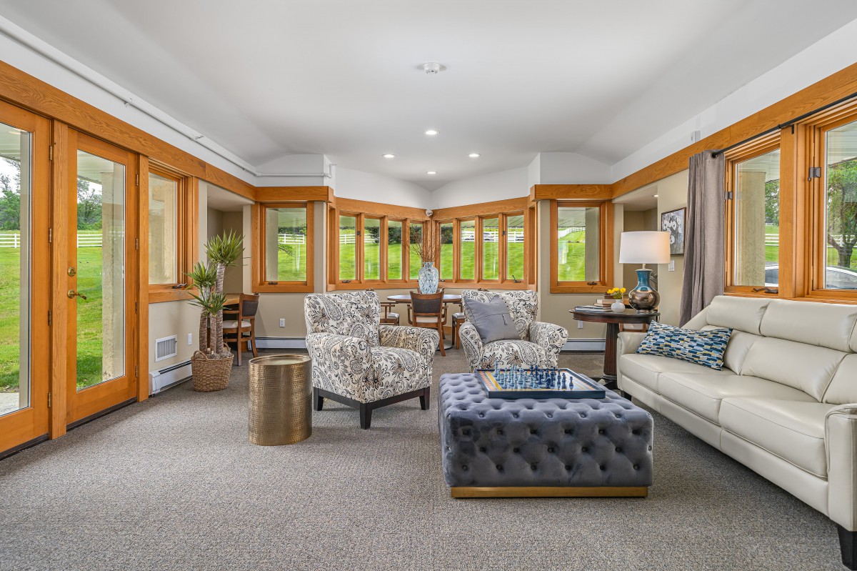 A spacious living room with modern furniture and large windows that let in natural light.