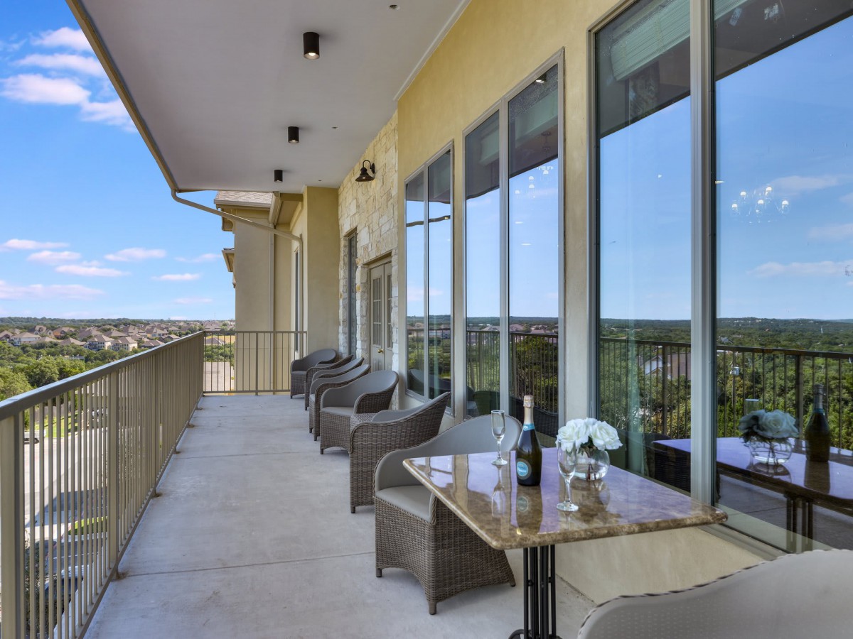 A spacious balcony with stylish furniture and a scenic view.
