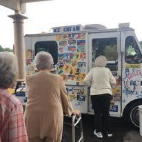 Senior citizens enjoy a visit to the ice cream truck on a warm day.