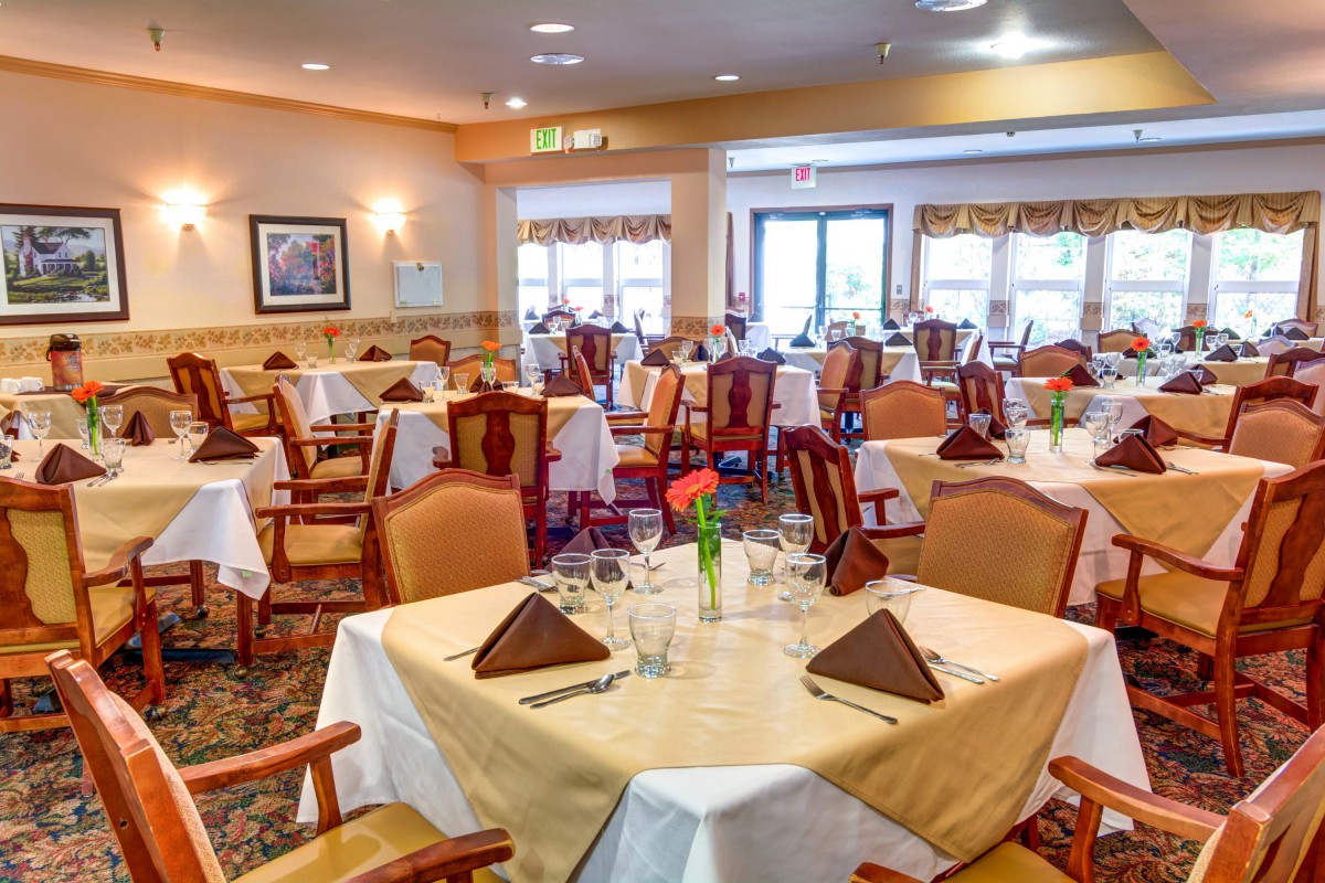 A well-decorated restaurant dining area with neatly arranged tables and chairs.