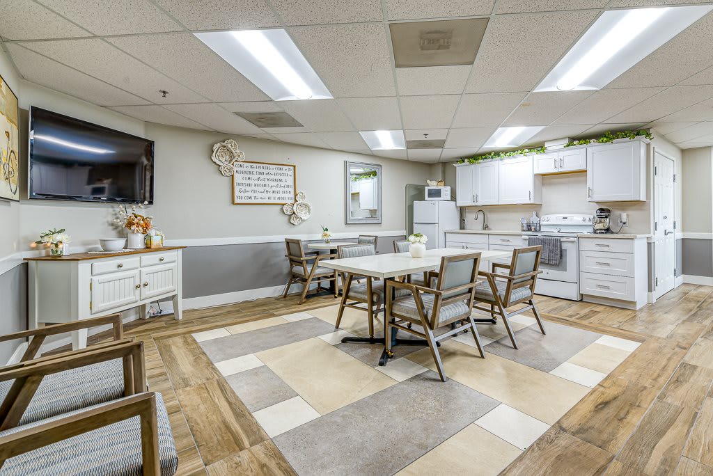 A well-lit, modern kitchen and dining area with ample seating.