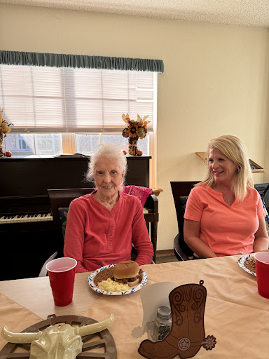 Two women enjoying a meal together in a cozy indoor setting.