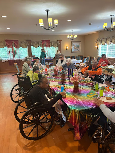 A lively community gathering at a retirement home, featuring residents enjoying a colorful meal together.