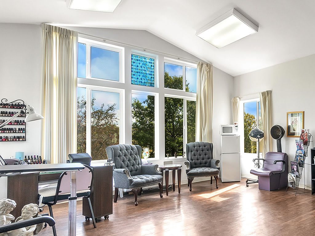 A bright and modern living room with large windows, natural light, and comfortable seating.