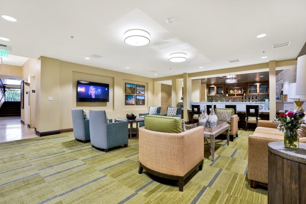 A modern lounge area with comfortable seating and a television.