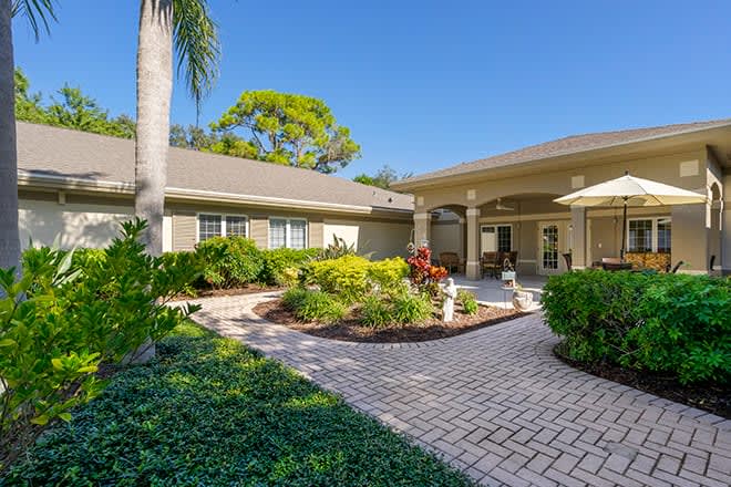 Beautiful home exterior with lush garden and patio.