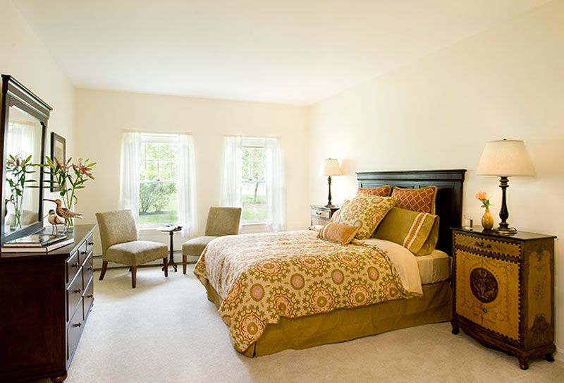 A cozy bedroom with elegant decor and natural lighting.