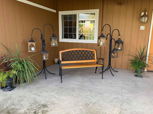 A cozy outdoor seating area with a decorative bench and lanterns.