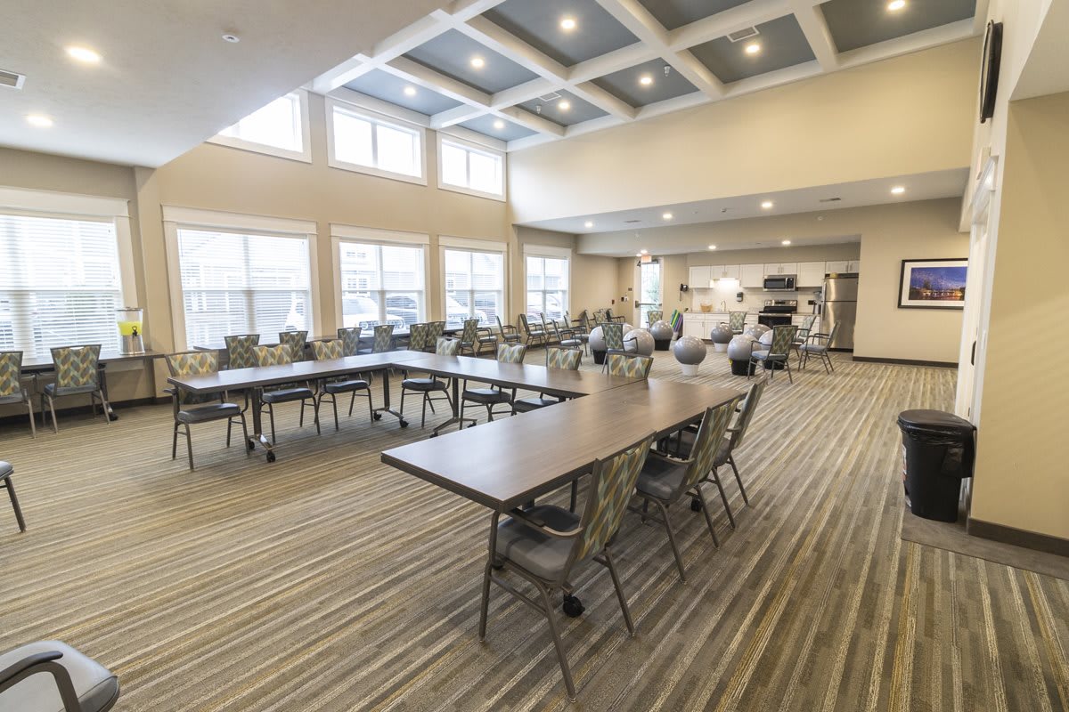 A spacious and modern conference room with tables and chairs arranged for a meeting.