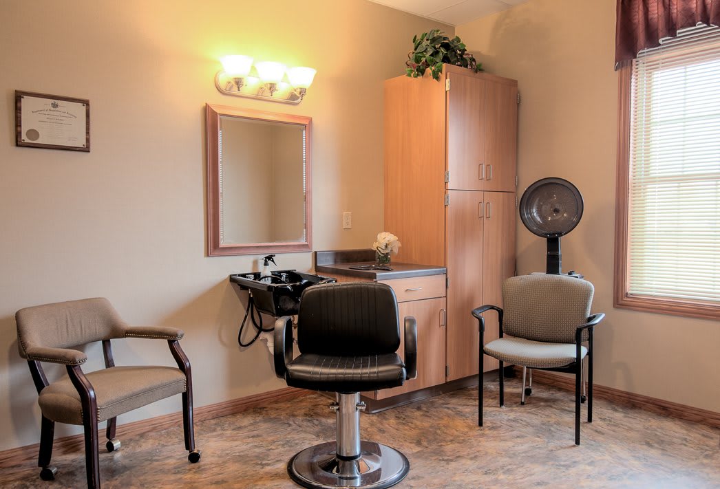 Interior of a hair salon with styling chairs and equipment.