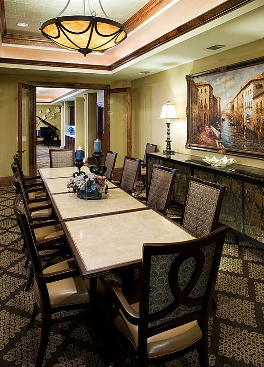 Elegant dining room with a long table and classic decor.