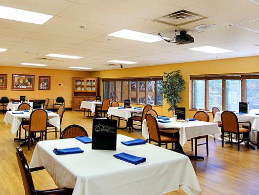 A cozy restaurant interior featuring neatly arranged tables and chairs, ready for guests.
