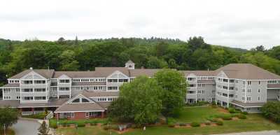 A large building surrounded by trees and greenery.