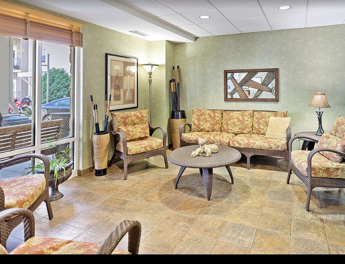 A cozy and well-decorated living room with comfortable seating and natural light.