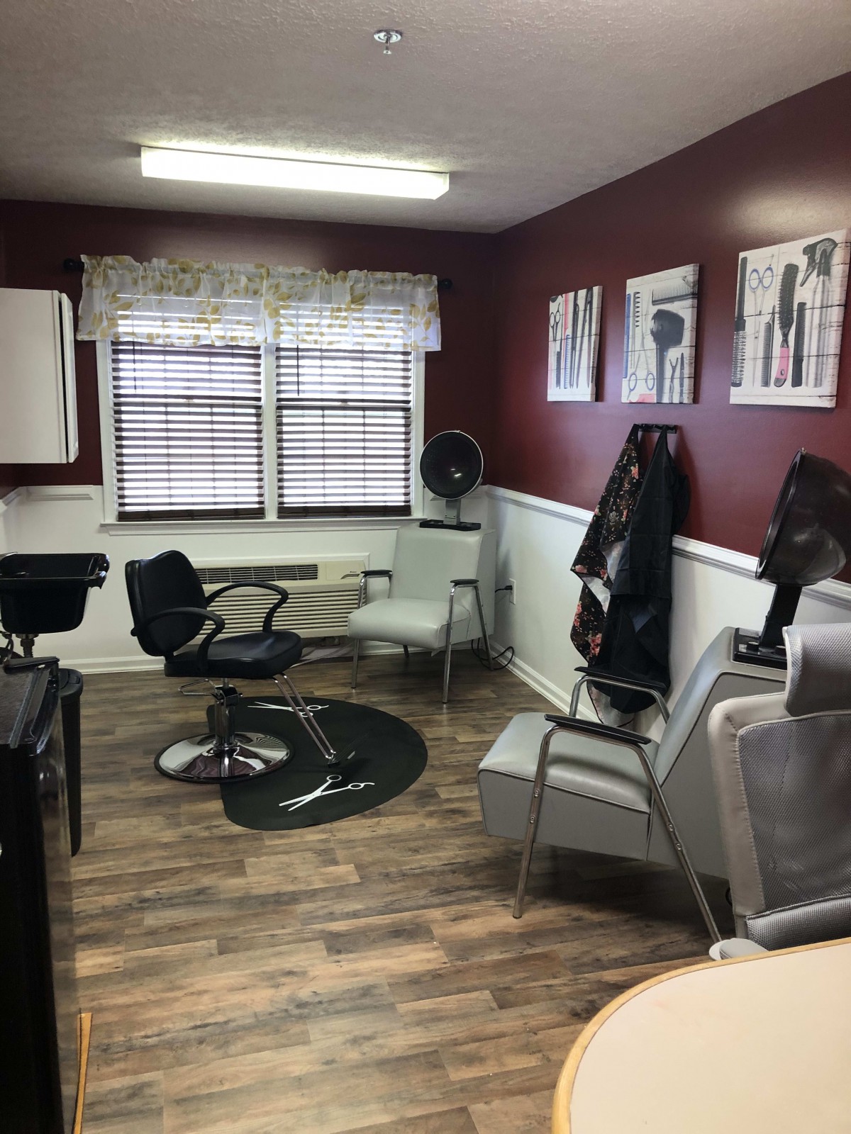 A cozy salon waiting area with multiple chairs and wall art.