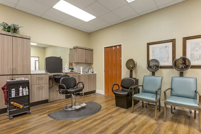 A modern hair salon interior with styling chairs and hair dryers.