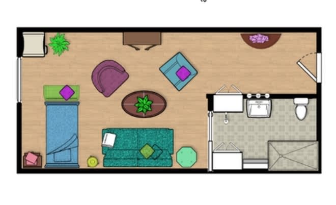 A color-coded floor plan showing a living room with various furniture pieces and a small kitchen area.