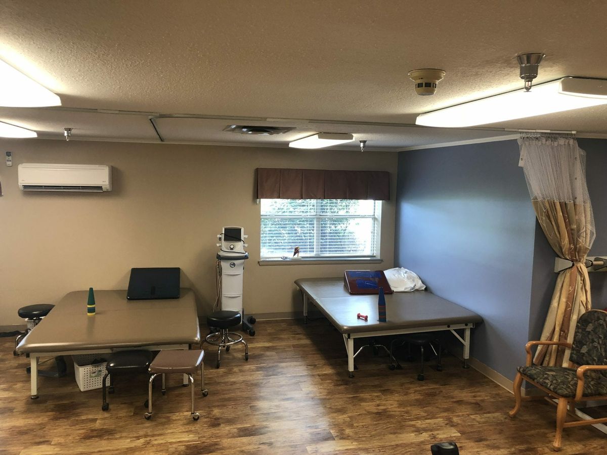 A therapy room with treatment beds and medical equipment.