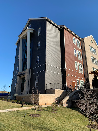 A modern multifamily building showcasing a blend of architectural styles and colors.