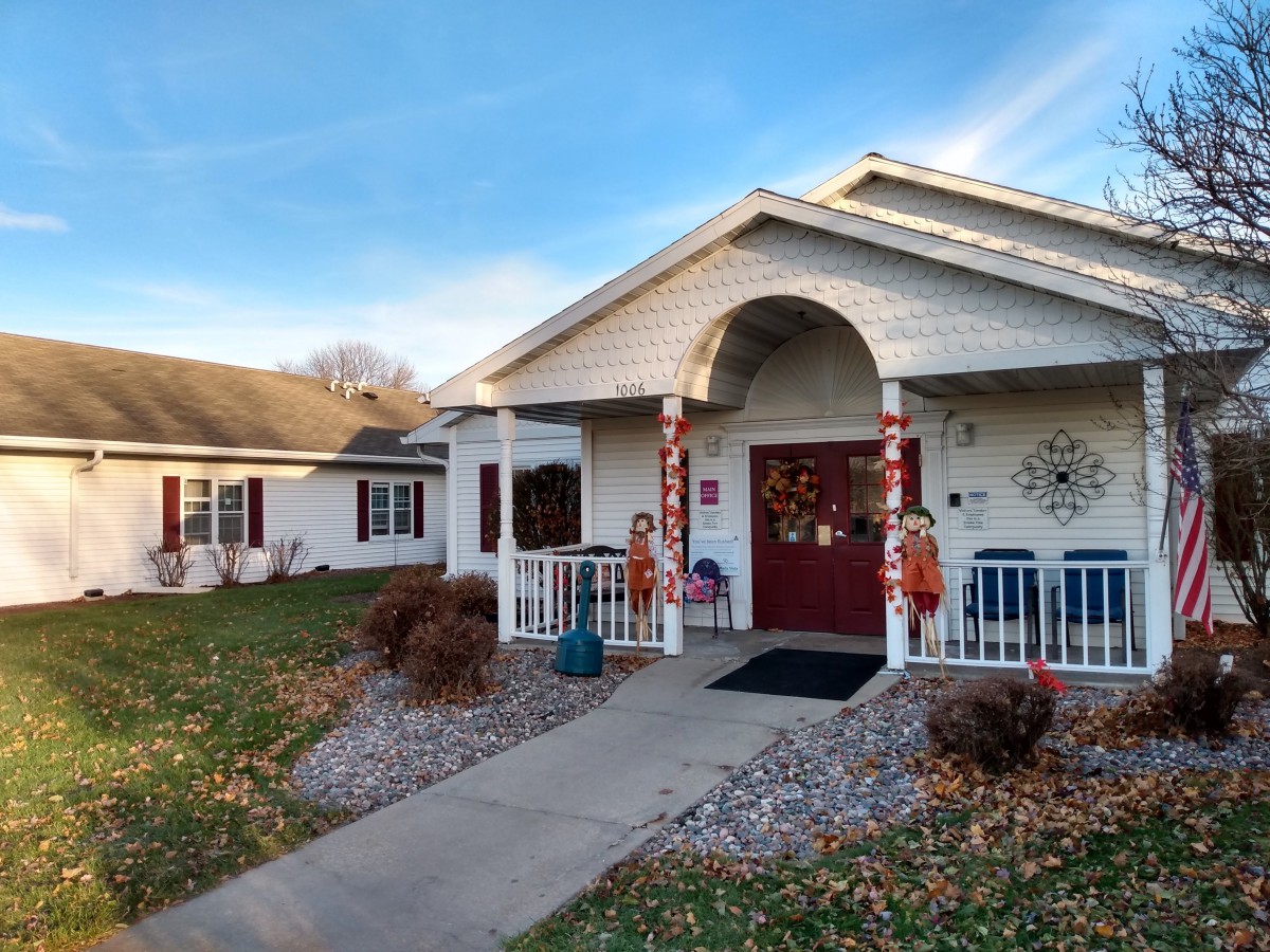 A charming house with a decorated front porch and a small garden.