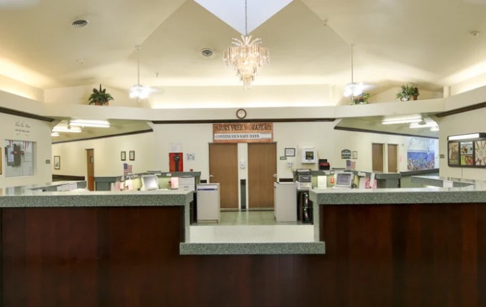 Modern reception area with a central desk and overhead lighting.