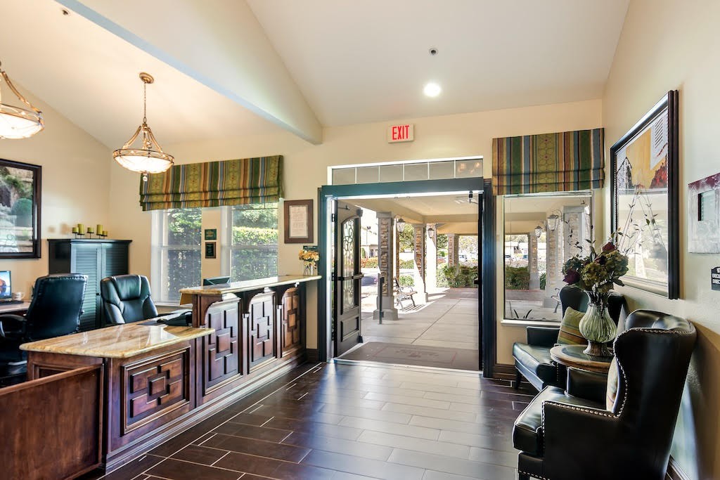 A welcoming lobby area featuring a reception desk and glass doors leading outside.