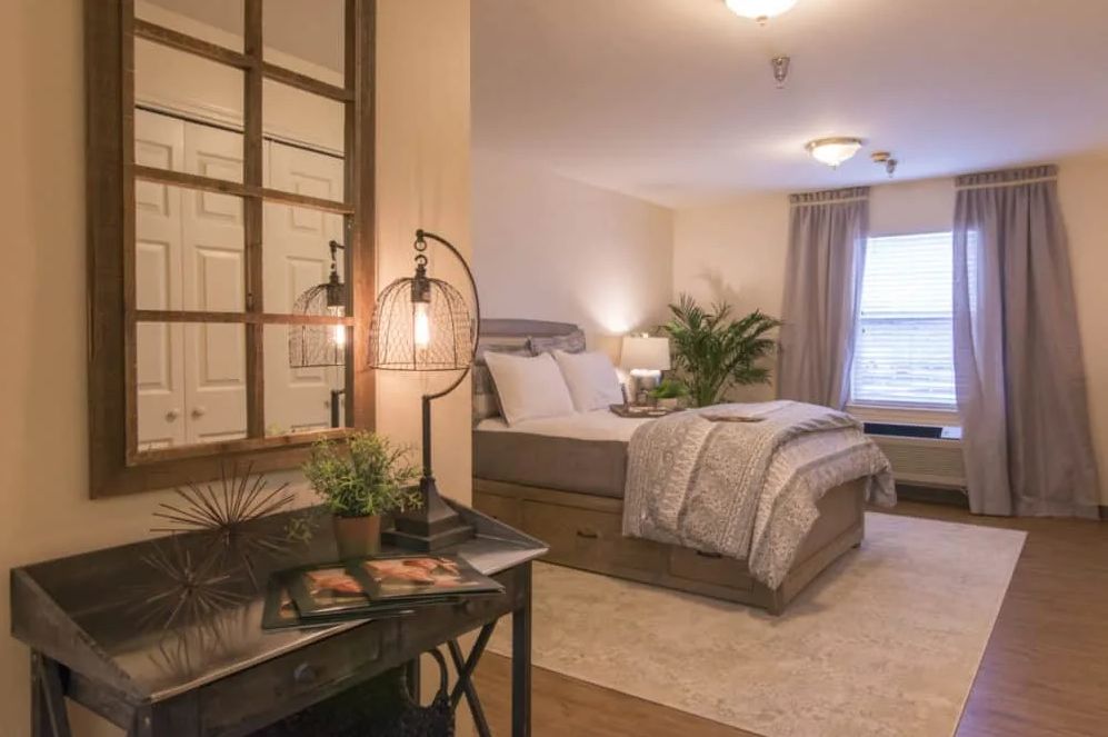 A cozy, modern bedroom with stylish decor and warm lighting.