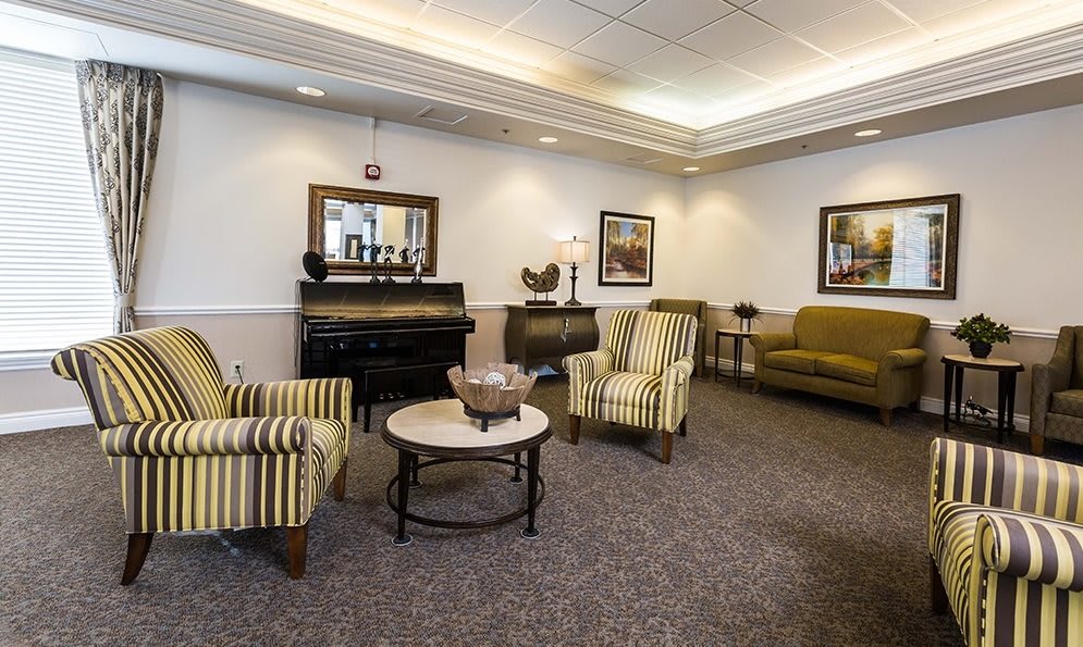 A cozy lounge area with comfortable seating and a piano.