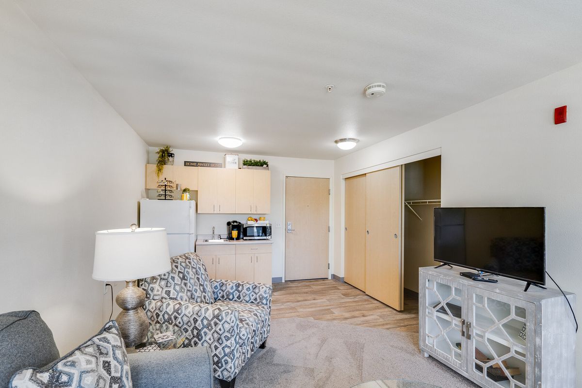 A cozy apartment living room with modern minimalist decor and an open layout.