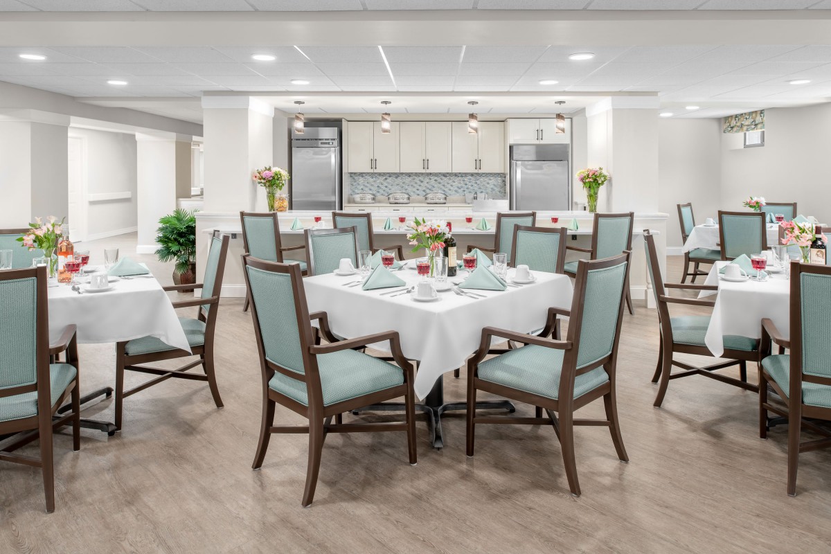 A modern and elegantly designed dining area with neatly arranged tables and chairs.