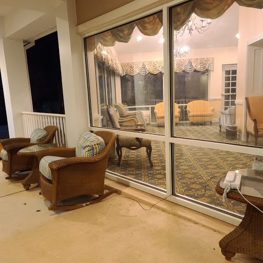 A cozy living room view with comfortable seating and soft evening light filtering through the glass doors.