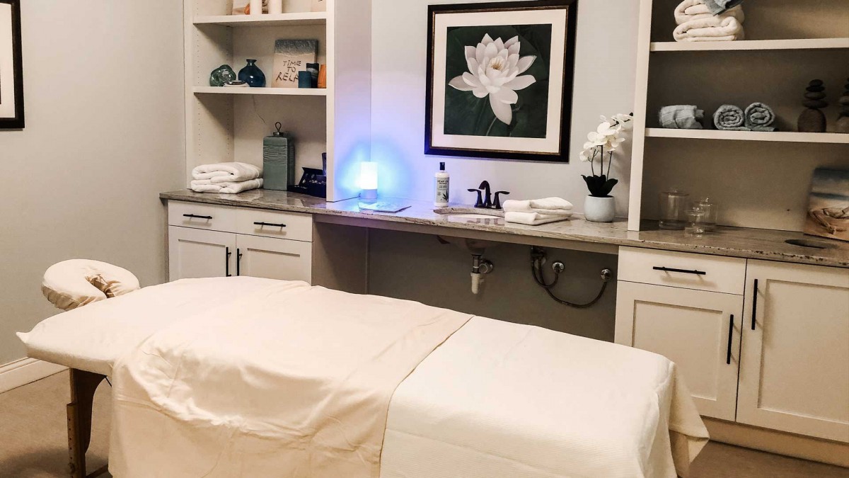 A tranquil spa room with a massage table, soothing decor, and calming ambiance.