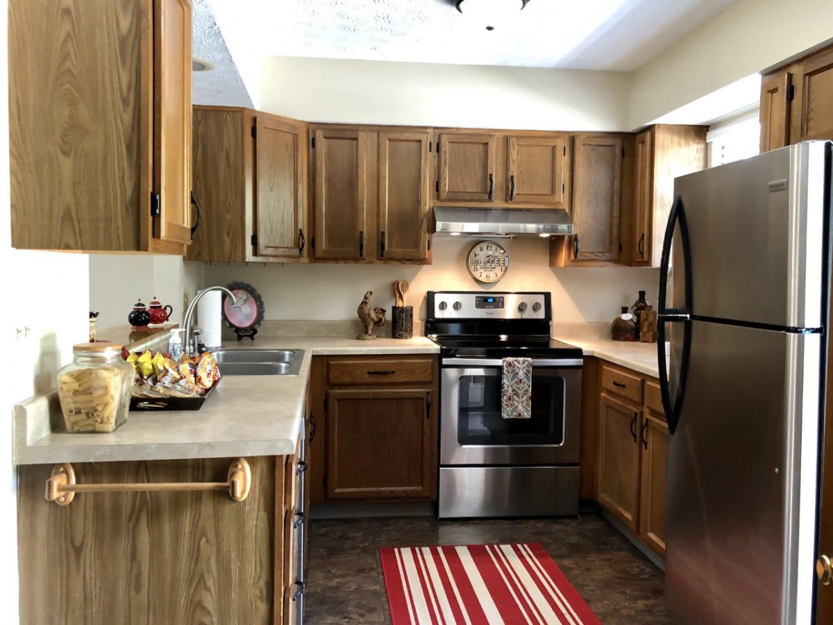 A modern kitchen with wooden cabinets and stainless steel appliances.