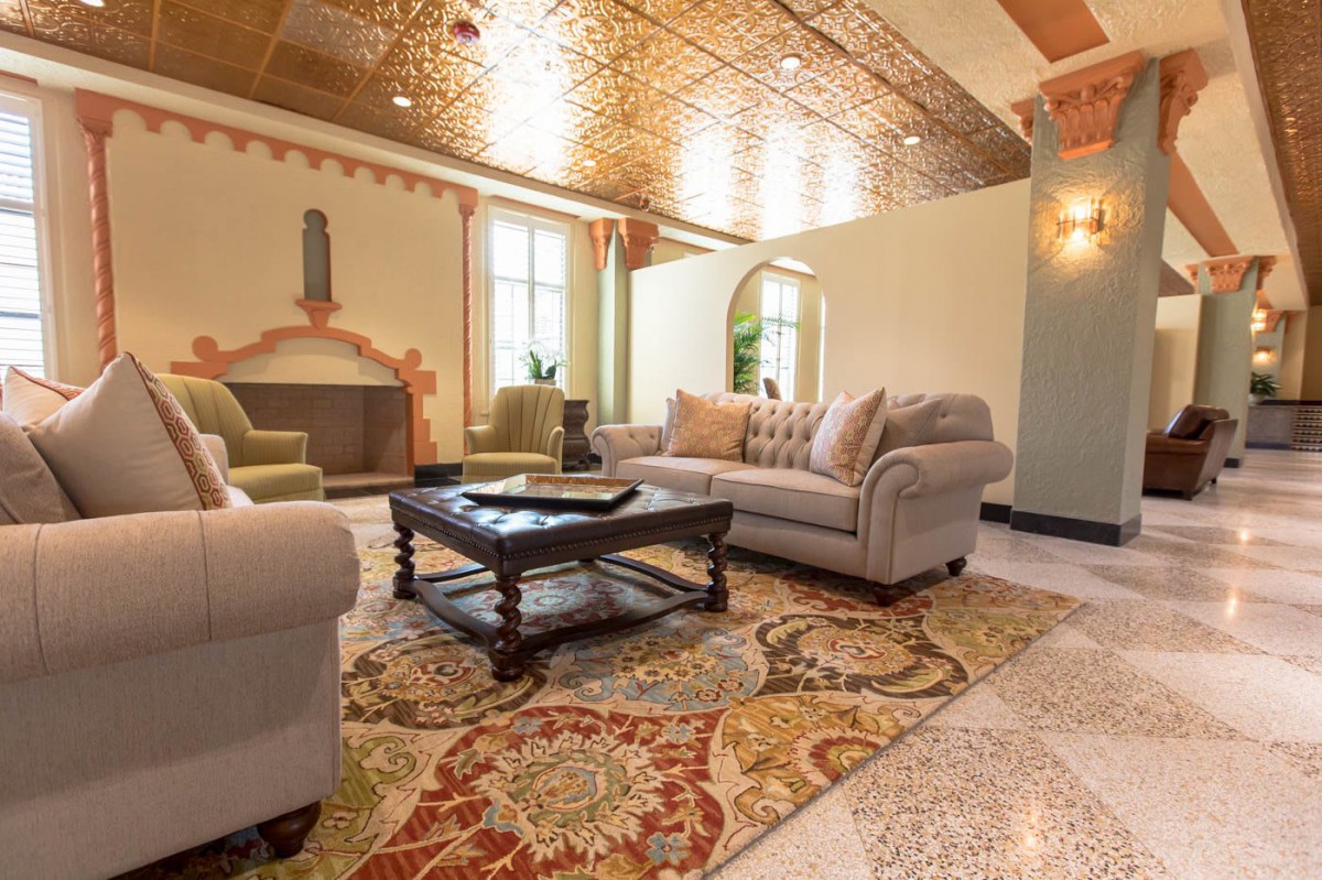 A beautifully decorated living room with a cozy sofa, elegant coffee table, and ornate rug.