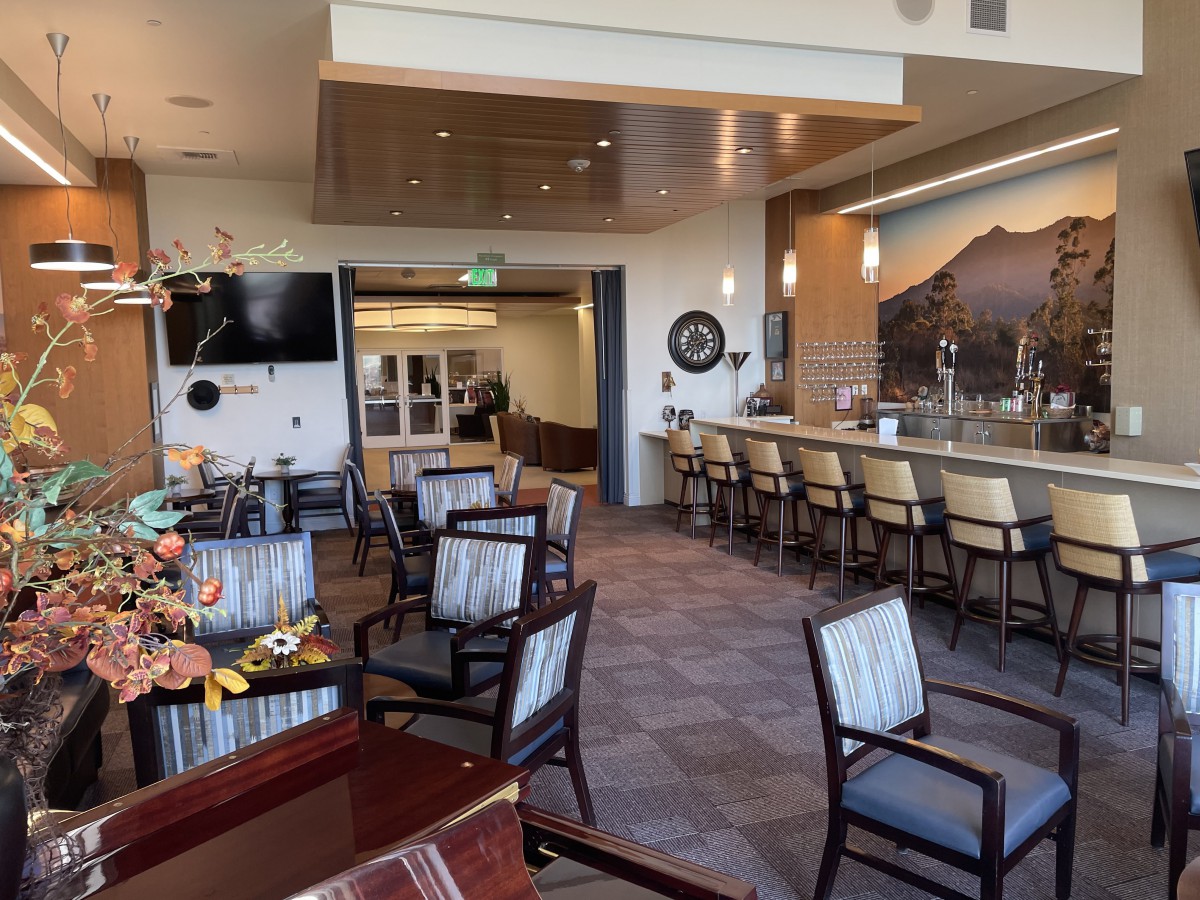An empty lounge and bar area with modern decor and comfortable seating.