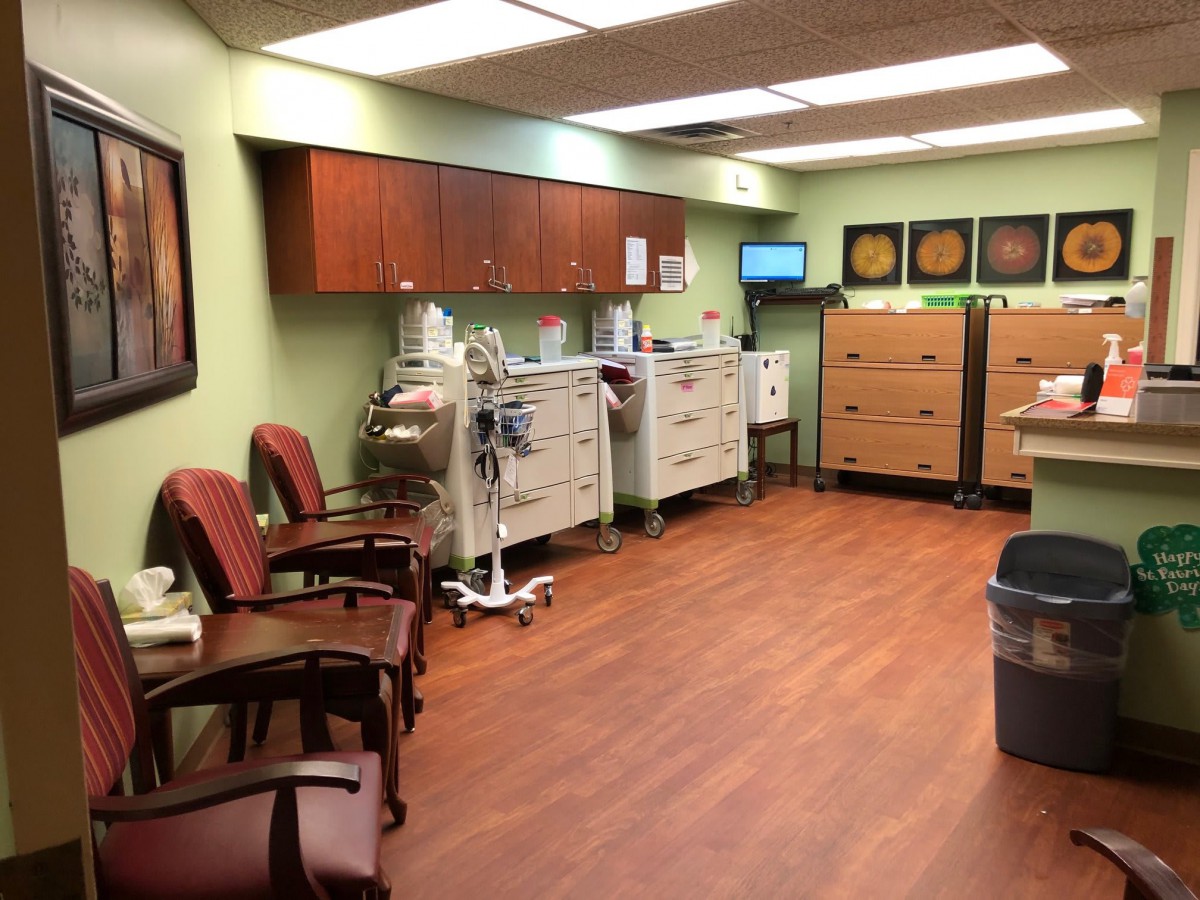A room in a medical facility equipped with chairs and medical equipment.
