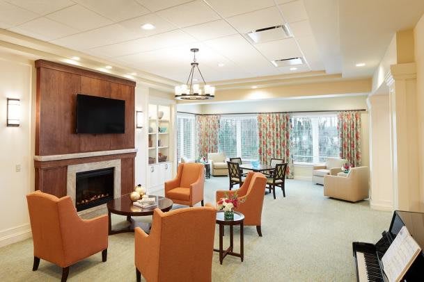 A modern living room with a fireplace and comfortable seating.