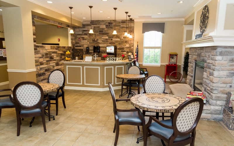 A cozy cafe interior with tables and a counter area.