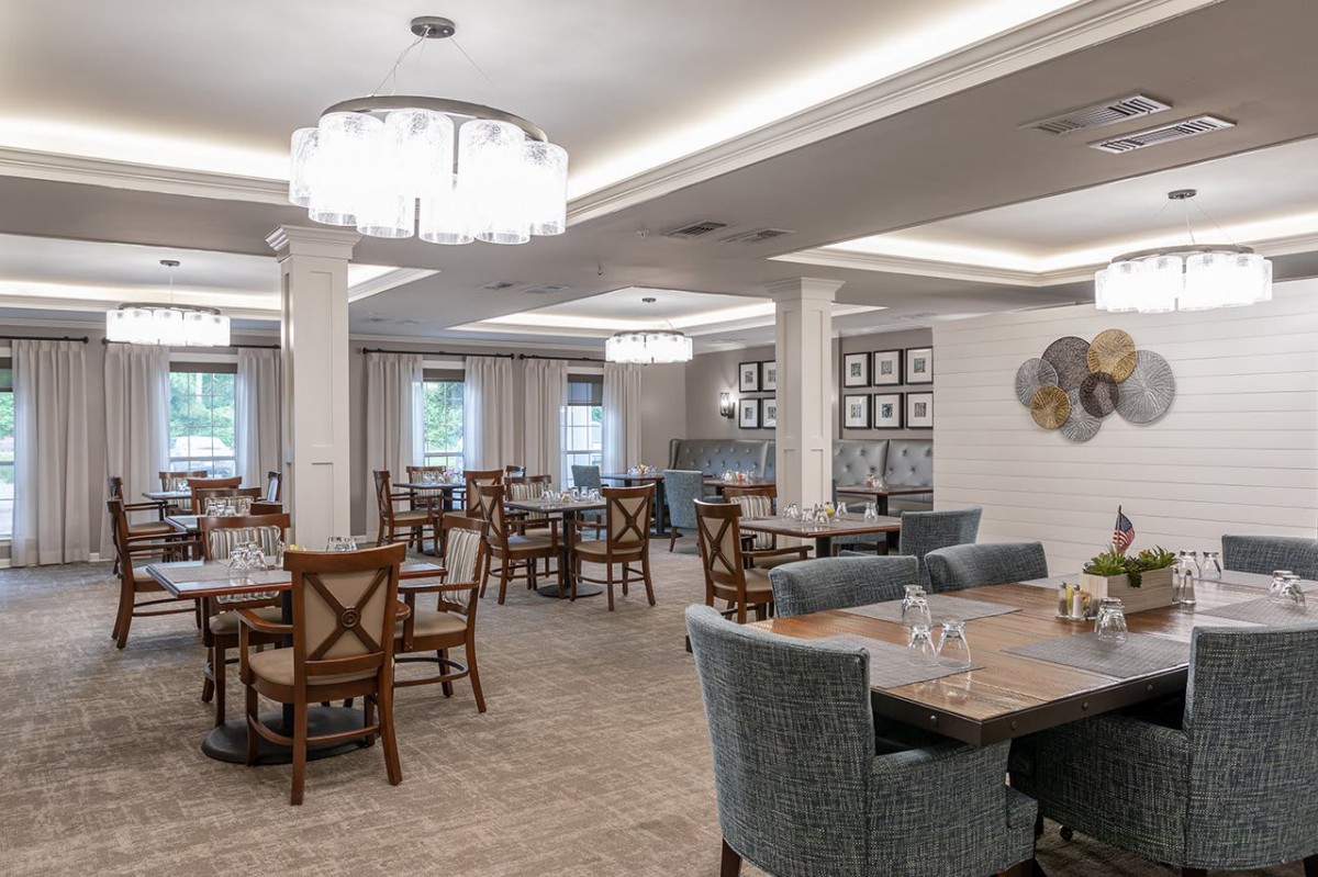 A well-lit dining room with elegant furniture and decor.