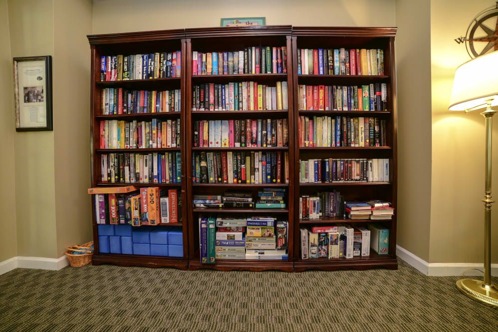 A neatly organized wooden bookshelf filled with various books.