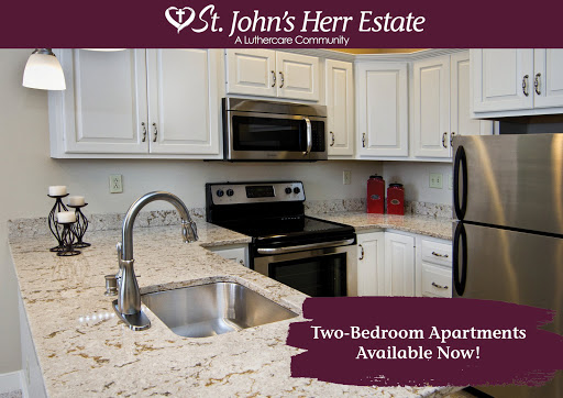 Explore the modern kitchen space of a two-bedroom apartment available at St. John's Herr Estate.