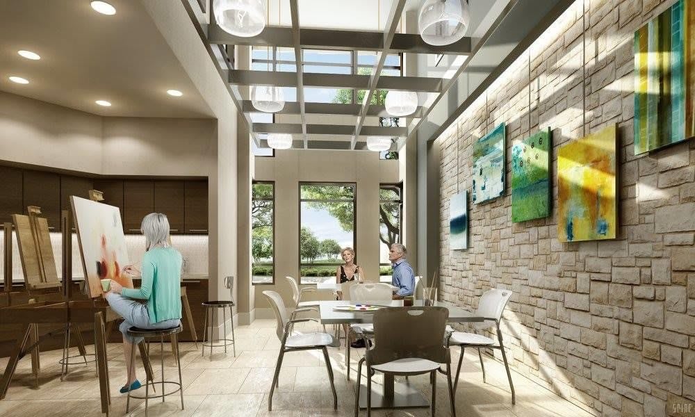 A modern dining area bathed in natural light with a glass ceiling and artwork on the walls.