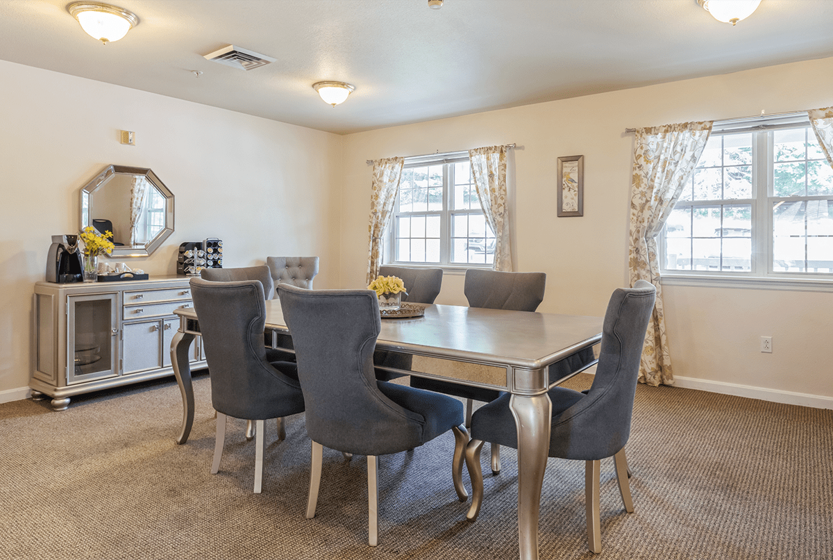 Elegant dining room with a large table and upholstered chairs.