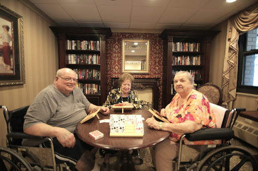 Seniors enjoying a game together in a cozy community space.