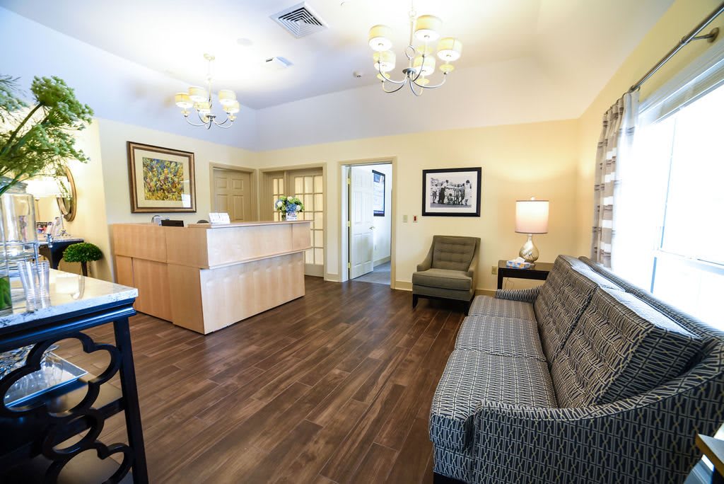 A cozy and well-lit reception area with comfortable seating and modern decor.