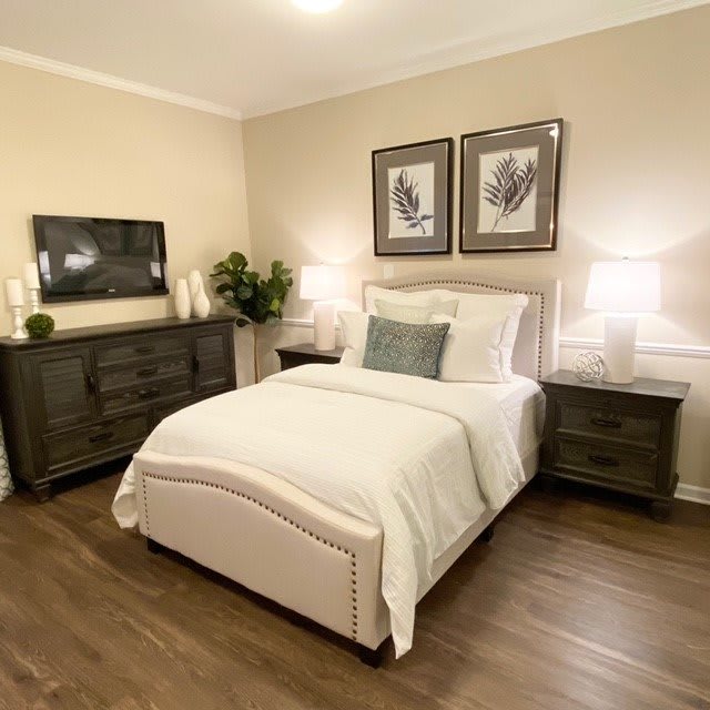 A cozy and elegantly decorated bedroom with warm lighting.